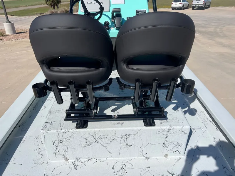 Slide: The Image of Rear view of a 2026 Shoalwater 23' Catamaran with black seats. - 28