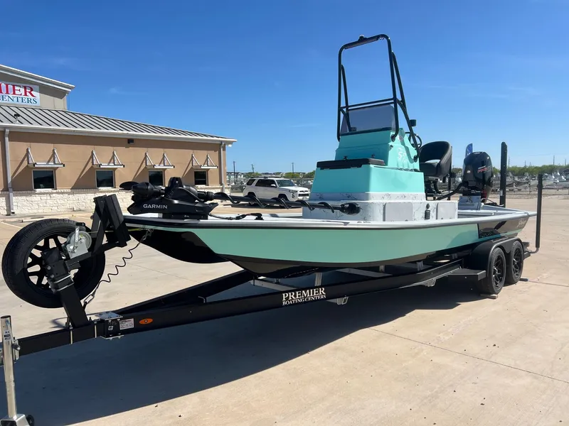 Slide: The Image of 2026 Shoalwater 23' Catamaran on trailer outside boating center. - 3