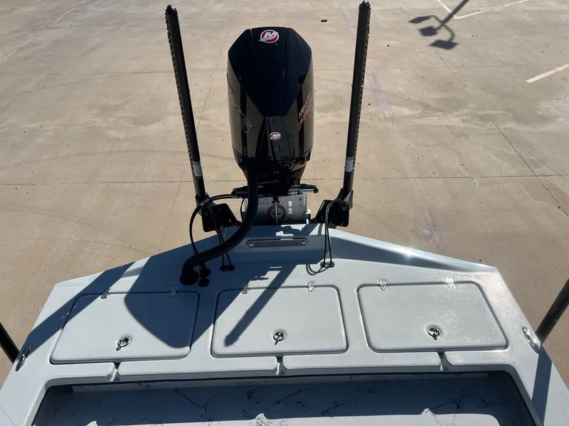 Slide: The Image of 2026 Shoalwater 23' Catamaran with outboard motor on concrete surface. - 30