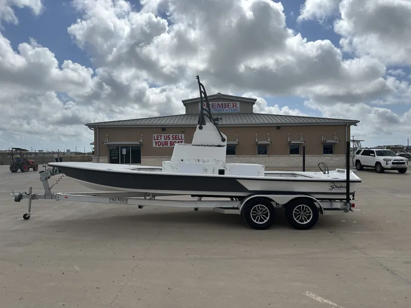 The Image of 2026 Shoalwater 23' Catamaran on trailer in front of building. - 1