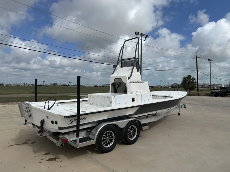 Slide: The Image of 2026 Shoalwater 23' Catamaran on trailer under cloudy sky. - 10