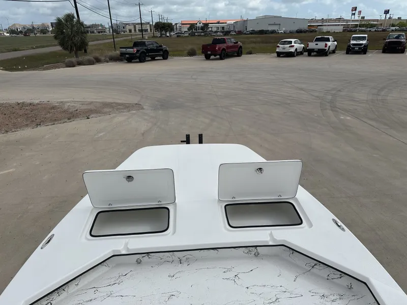 Slide: The Image of Shoalwater 23' Catamaran 2026 on parking lot with open storage compartments. - 11