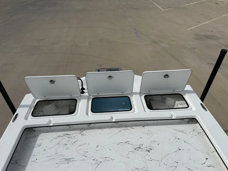 Slide: The Image of Shoalwater 23' Catamaran 2026 with open storage compartments on deck. - 23