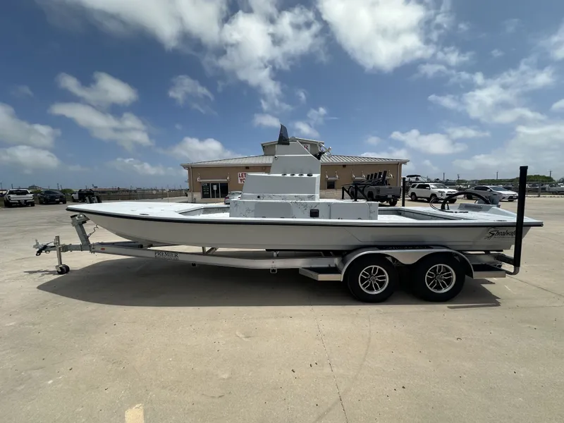The Image of 2026 Shoalwater 23' Catamaran on trailer under blue sky. - 1