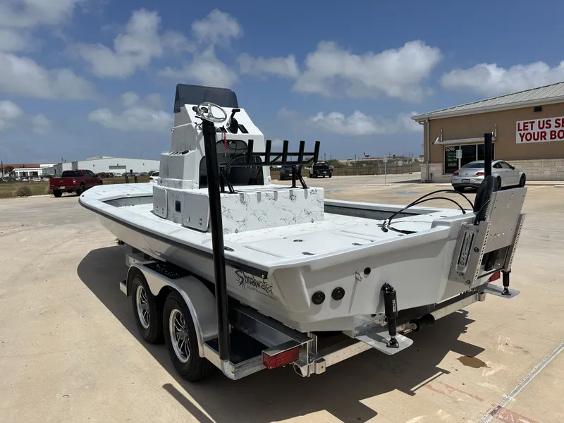 Slide: The Image of 2026 Shoalwater 23' Catamaran parked outdoors on a trailer. - 11