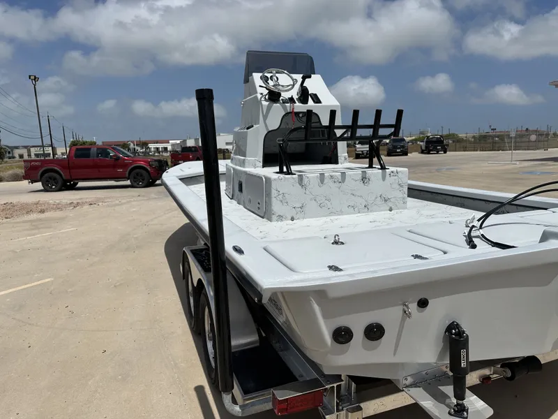 Slide: The Image of 2026 Shoalwater 23' Catamaran parked outdoors on a trailer. - 12