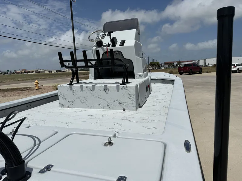 Slide: The Image of 2026 Shoalwater 23' Catamaran on a parking lot under sunny skies. - 13