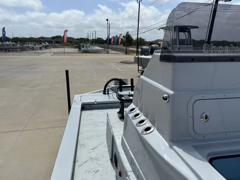 Slide: The Image of 2026 Shoalwater 23' Catamaran on parking lot under sunny skies. - 23