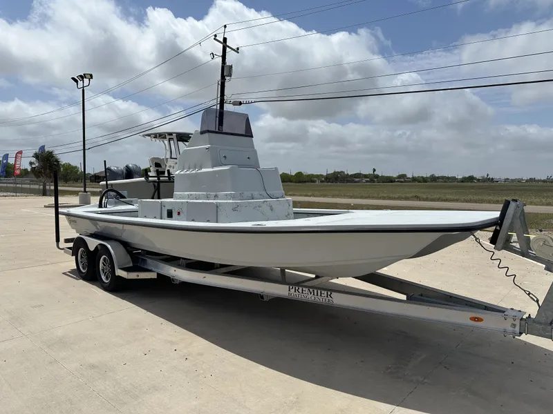 Slide: The Image of 2026 Shoalwater 23' Catamaran on trailer under cloudy sky. - 7