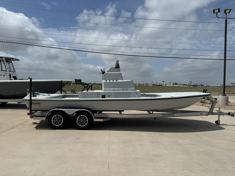 Slide: The Image of 2026 Shoalwater 23' Catamaran on trailer under cloudy sky. - 8