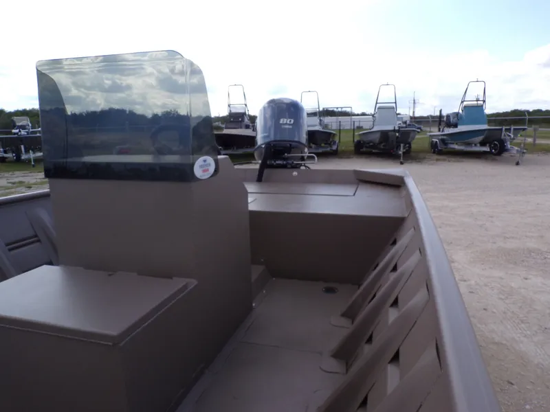 Slide: The Image of Weldcraft 1850 MUVDD SP DLX CC FO boat, 2026 model, parked outdoors. - 21