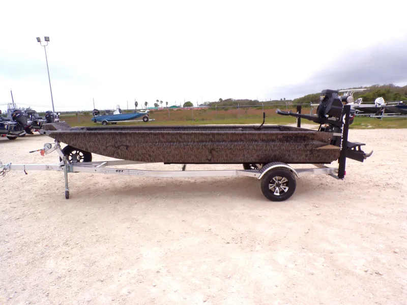 The Image of 2026 Xpress Bayou 180 boat parked on trailer outdoors. - 1