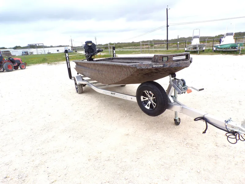 Slide: The Image of 2026 Xpress Bayou 180 boat on trailer parked outdoors. - 11