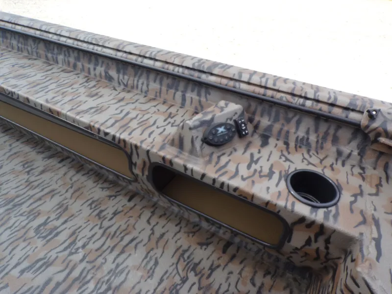 Slide: The Image of 2026 Xpress Bayou 180 boat with camouflage pattern and control console. - 18