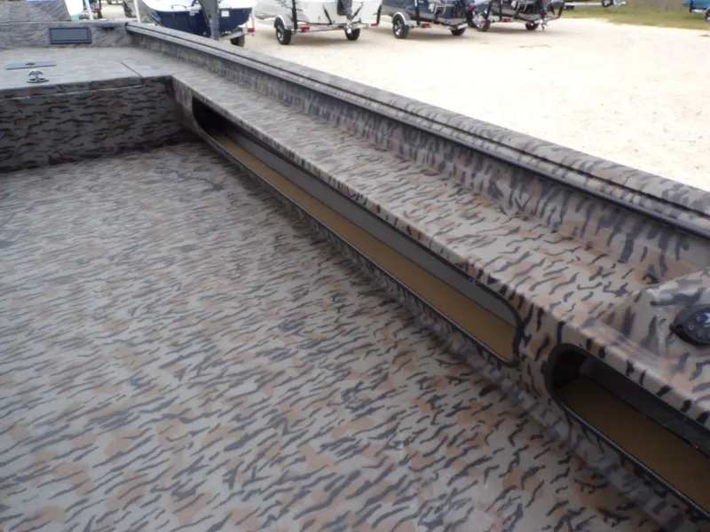 Slide: The Image of Interior view of Xpress Bayou 180 boat, 2026 model, featuring camouflage pattern. - 19
