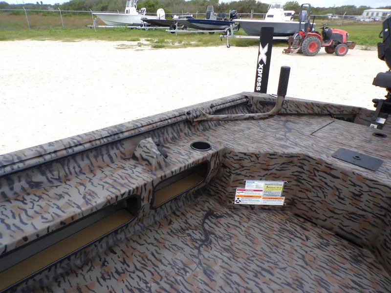 Slide: The Image of 2026 Xpress Bayou 180 boat with camouflage pattern and accessories. - 20