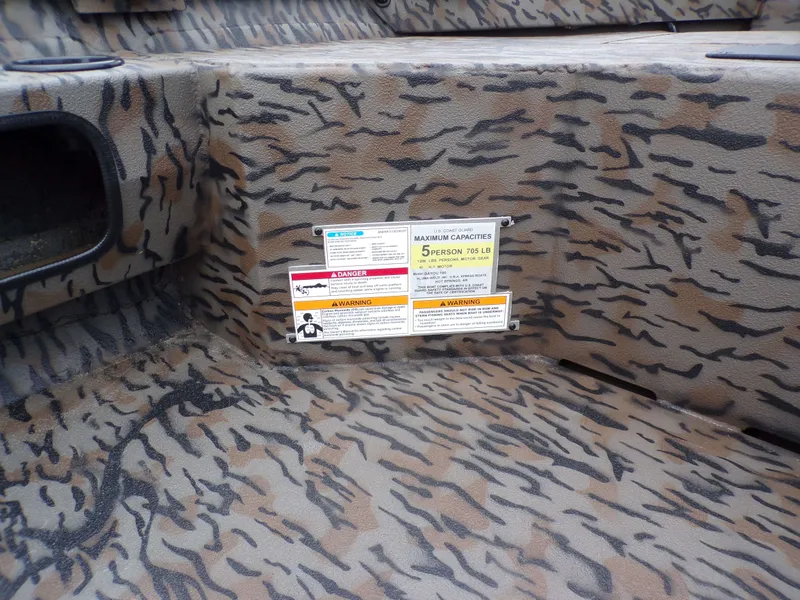 Slide: The Image of Xpress Bayou 180 boat with camouflage pattern and capacity label. - 21