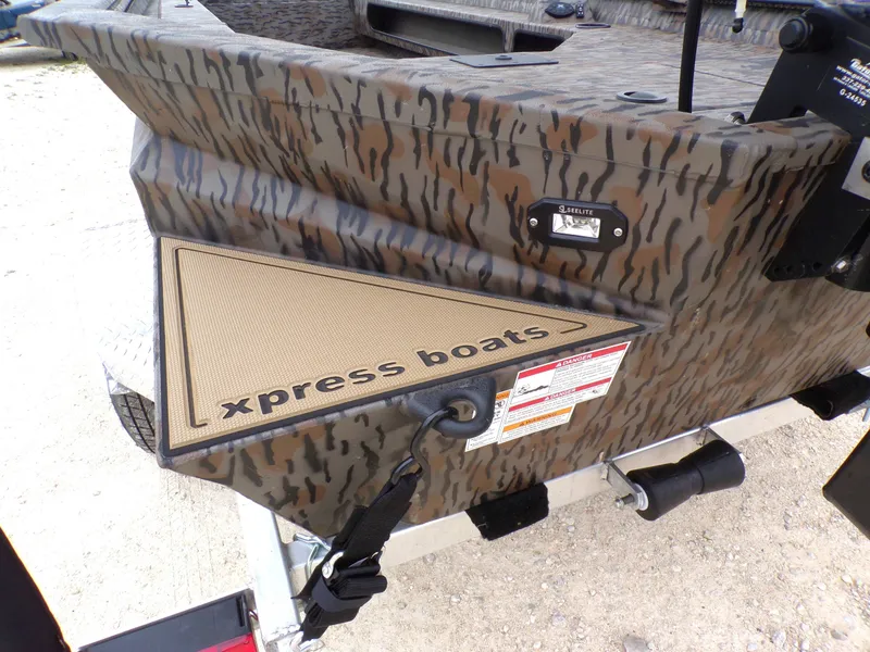 Slide: The Image of 2026 Xpress Bayou 180 boat with camouflage pattern and logo. - 23