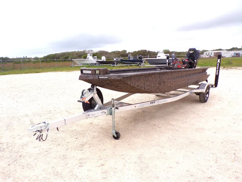 Slide: The Image of 2026 Xpress Bayou 180 boat on trailer parked outdoors. - 9