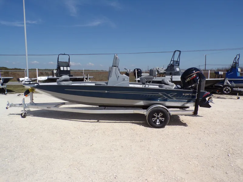 The Image of 2025 Xpress H20B Bay boat on trailer outdoors. - 1