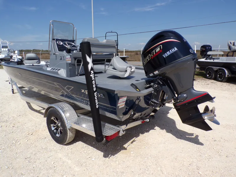 Slide: The Image of 2025 Xpress H20B Bay boat with Yamaha engine on trailer. - 11