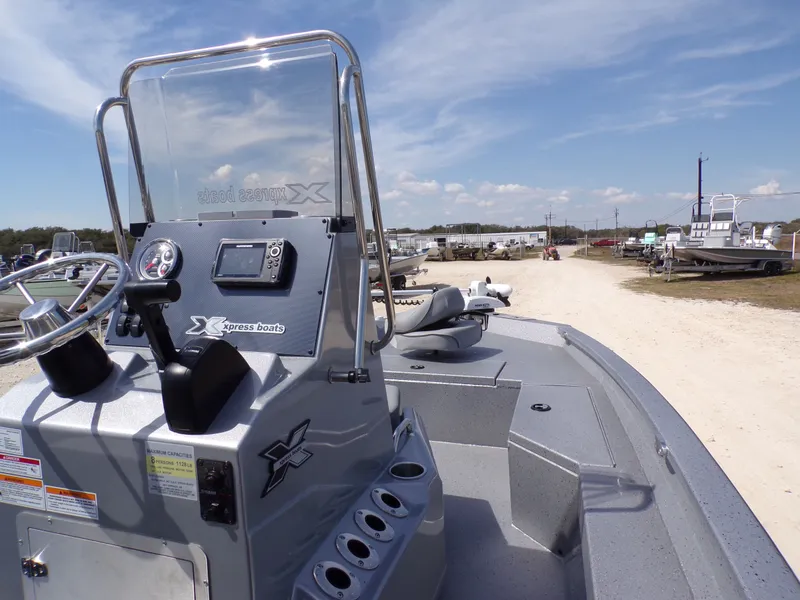 Slide: The Image of 2025 Xpress H20B Bay boat with steering console under blue sky. - 17