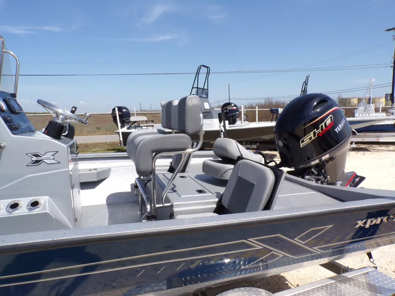 Slide: The Image of 2025 Xpress H20B Bay boat with Yamaha outboard motor. - 21