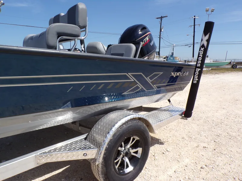 Slide: The Image of 2025 Xpress H20B Bay boat on trailer, side view. - 22