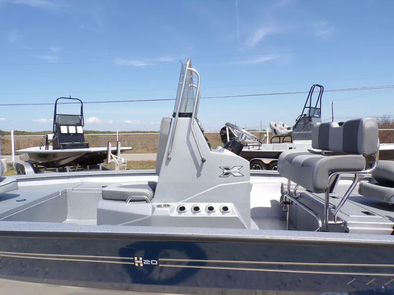 Slide: The Image of 2025 Xpress H20B Bay boat with gray seats and steering console. - 23