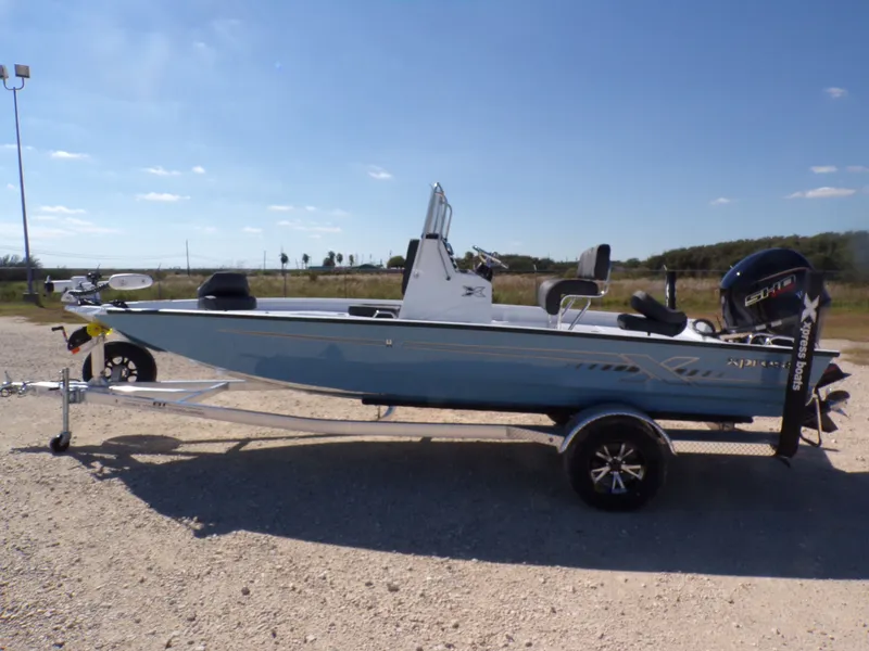 The Image of 2026 Xpress H20B Bay boat on trailer outdoors. - 1