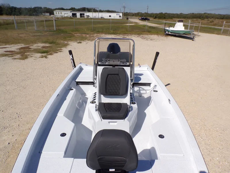Slide: The Image of 2026 Xpress H20B Bay boat parked on gravel lot. - 12