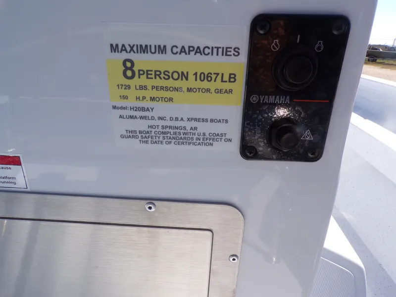 Slide: The Image of Xpress H20B Bay 2026 boat capacity label, 8 persons, 1067 pounds. - 26