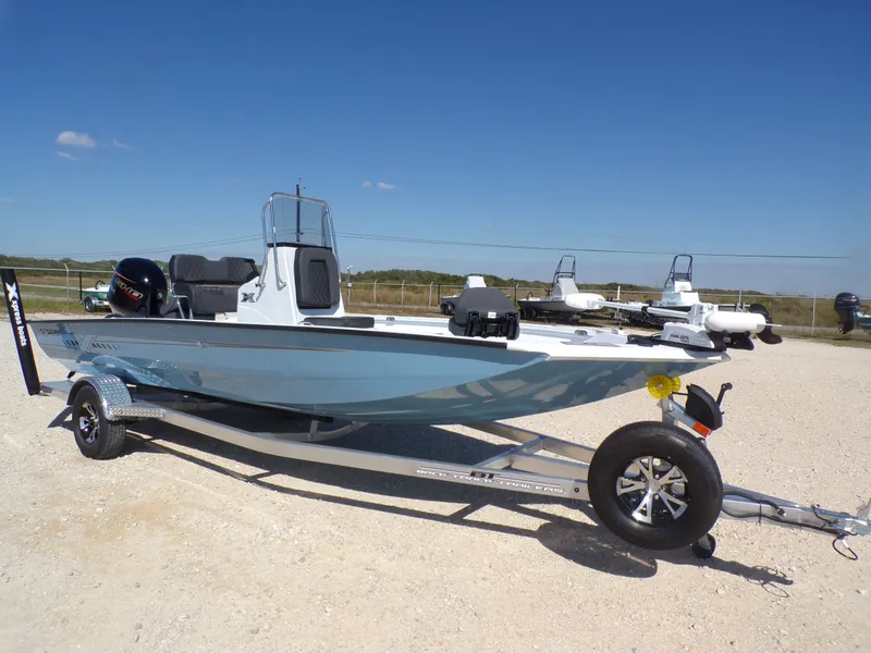 Slide: The Image of 2026 Xpress H20B Bay boat on trailer, blue sky. - 6