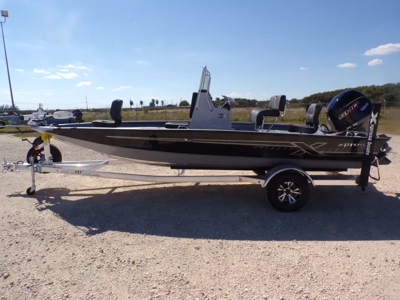 The Image of 2026 Xpress H20B Bay boat on trailer outdoors. - 1