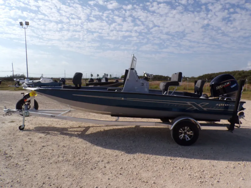 The Image of 2026 Xpress H20B Bay boat on trailer, side view. - 1