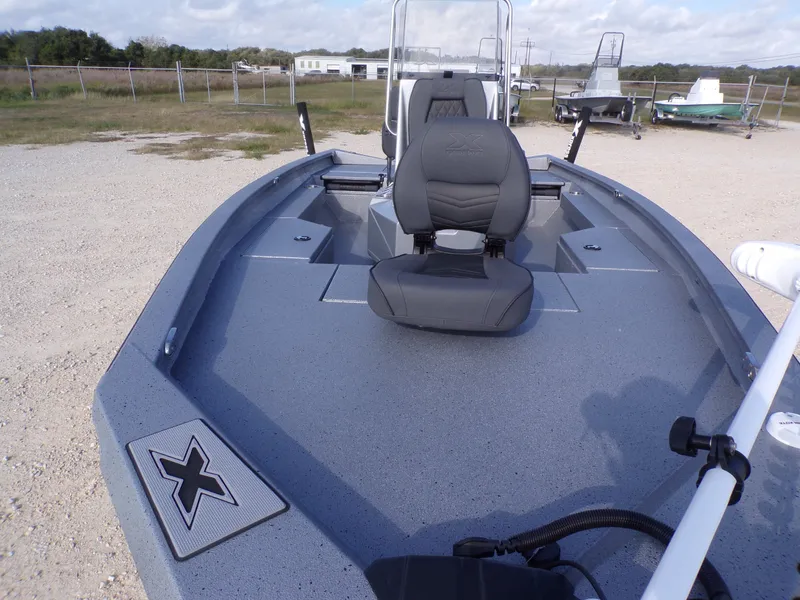 Slide: The Image of 2026 Xpress H20B Bay boat with gray deck and seat. - 12