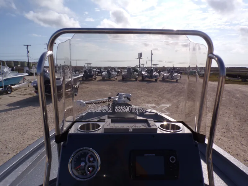 Slide: The Image of 2026 Xpress H20B Bay boat cockpit view in a parking lot. - 24