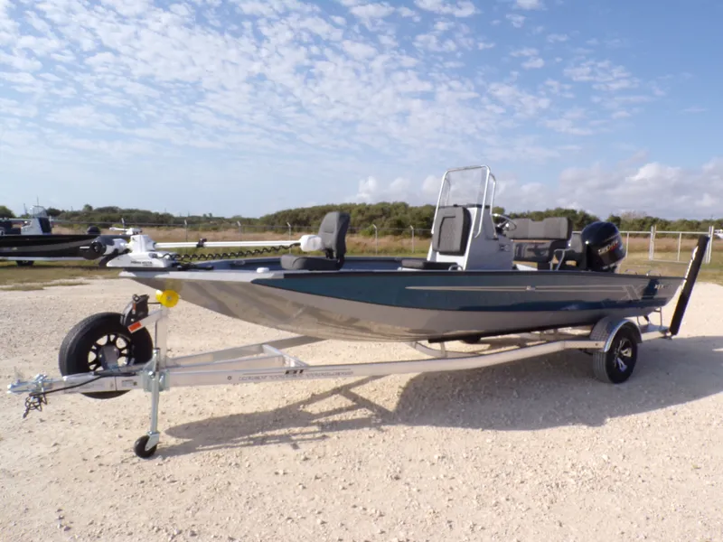 Slide: The Image of 2026 Xpress H20B Bay boat on trailer, blue sky. - 3