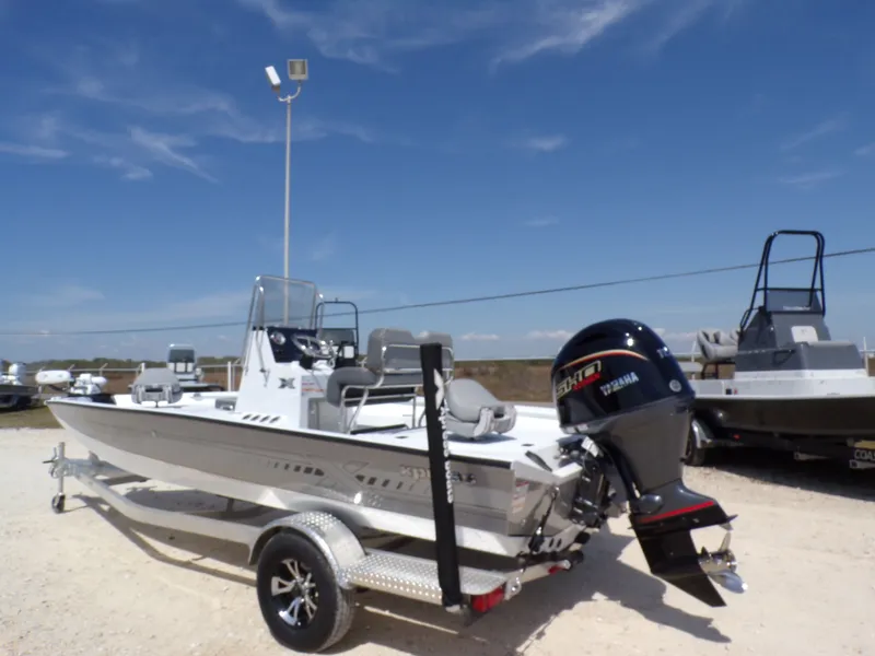 Slide: The Image of 2025 Xpress H20B Bay boat with Yamaha motor on trailer. - 11