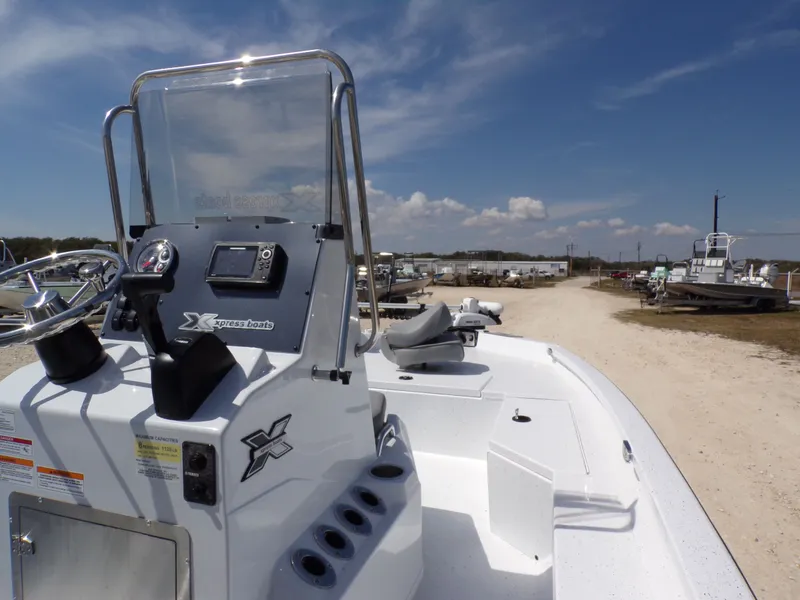 Slide: The Image of 2025 Xpress H20B Bay boat on a sunny parking lot. - 17