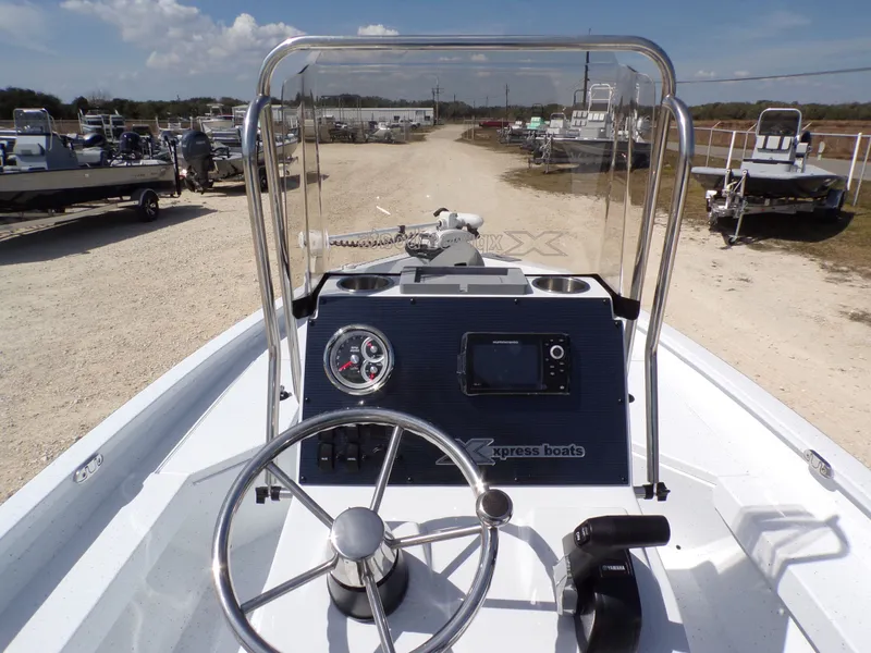 Slide: The Image of 2025 Xpress H20B Bay boat cockpit with controls and instruments. - 19