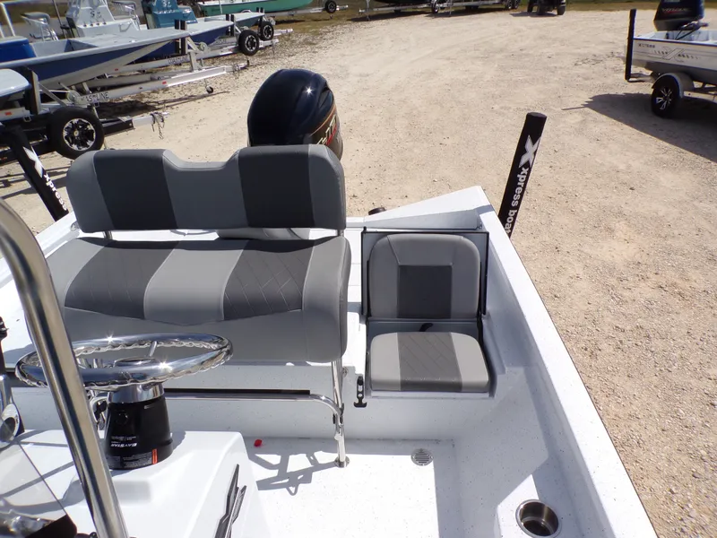 Slide: The Image of 2025 Xpress H20B Bay boat with gray seats and steering console. - 21