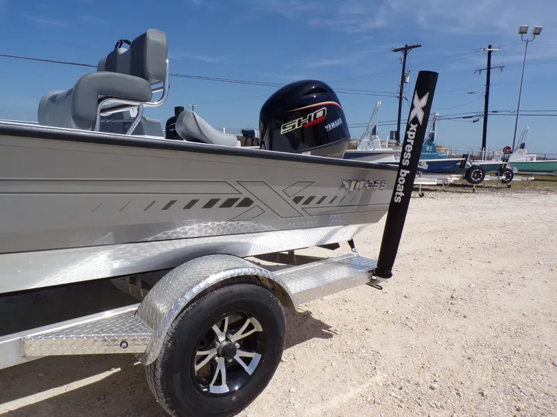 Slide: The Image of 2025 Xpress H20B Bay boat on trailer with Yamaha engine. - 23