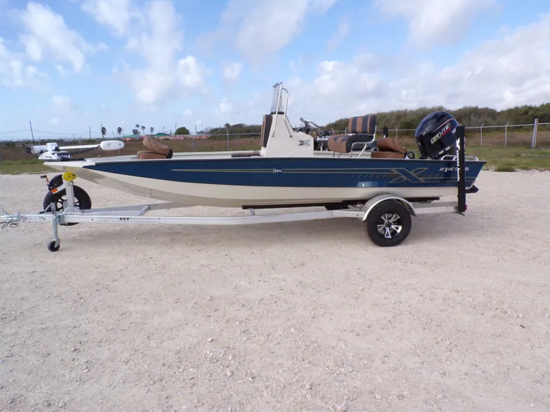 The Image of 2026 Xpress H20BAY boat on trailer, side view. - 1