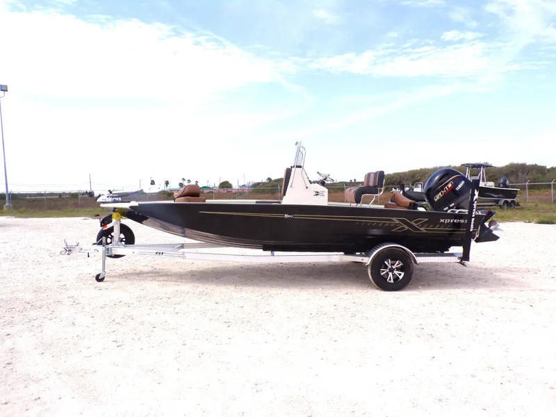 The Image of 2026 Xpress H20BAY boat parked on trailer outdoors. - 1
