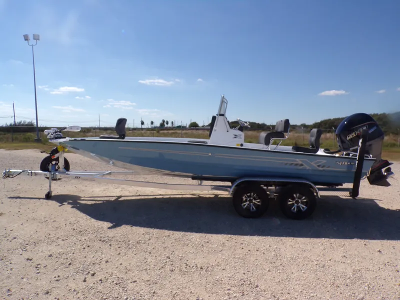 The Image of 2026 Xpress H22B Bay boat on trailer, sunny day. - 1