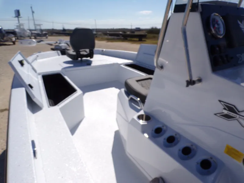 Slide: The Image of 2026 Xpress H22B Bay boat with open storage and helm console. - 19