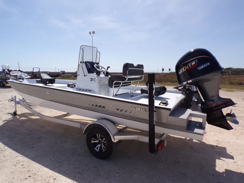 Slide: The Image of 2026 Xpress SW20B boat with Yamaha engine on trailer. - 13
