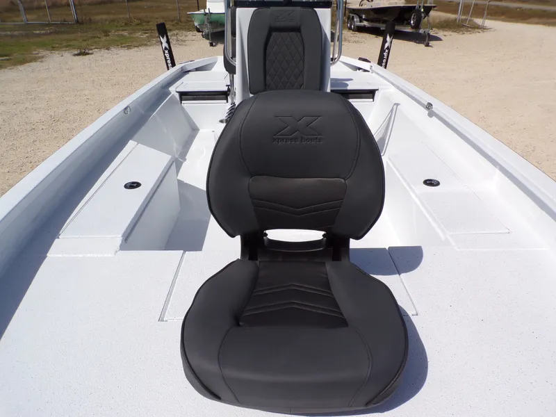Slide: The Image of 2026 Xpress SW20B boat with black seat on white deck. - 16