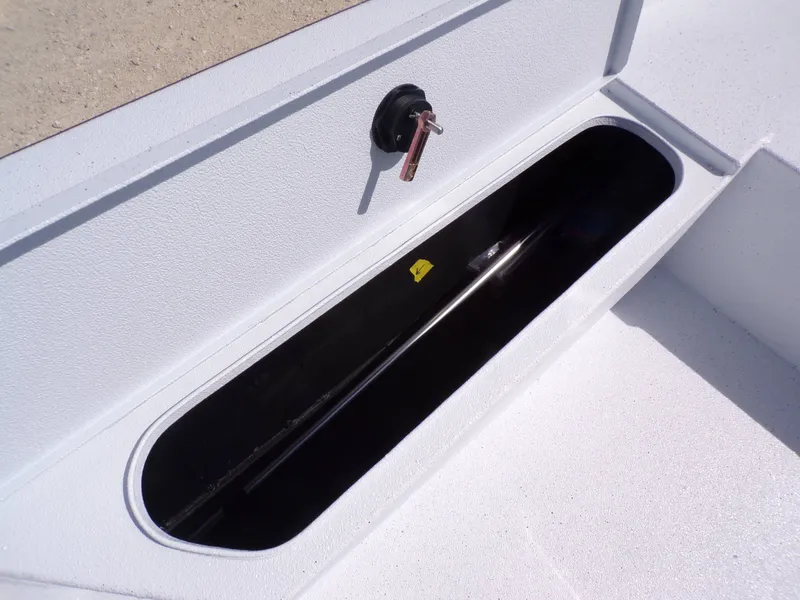 Slide: The Image of Xpress SW20B 2026 boat storage compartment with open lid. - 19